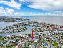 Island home with a waterfront canal, surrounded by water with beachfront and waterfront community at 336 Boca Ciega Dr, Madeira Beach, FL 33708