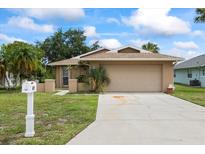 Inviting single-story home with a well-maintained lawn, two-car garage, and convenient mailbox at 4543 Dewey Dr, New Port Richey, FL 34652