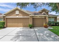 Charming single-Gathering home with a spacious three-car garage and manicured landscaping at 9309 Edistro Pl, New Port Richey, FL 34654