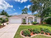 Charming single-story home featuring a well-manicured lawn and a two-car garage at 9431 Spring Hill Dr, Spring Hill, FL 34608