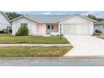 Charming single-story home with a well-manicured lawn and a two-car garage at 9433 Stonewall Ln, New Port Richey, FL 34655