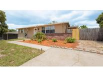 Charming single-story home featuring a well-manicured front yard and inviting curb appeal at 9635 Century Dr, Spring Hill, FL 34608