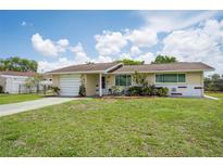Charming single story home with a well-manicured lawn and front yard at 10600 Oleander Dr, Port Richey, FL 34668