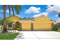 Charming single Gathering home with a two-car garage, beautiful landscaping and stone accents at 11204 Biddeford Pl, New Port Richey, FL 34654