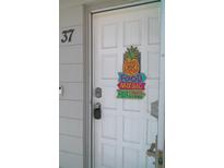 Inviting front door with a decorative pineapple, 'food, music, fun' sign, and visible unit number at 2261 Swedish Dr # 37, Clearwater, FL 33763