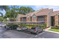 View of condo units, carport, landscaping and reserved parking spots at 2500 Winding Creek Blvd # I106, Clearwater, FL 33761