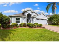 Beautiful single-story home with lush landscaping and a well-maintained lawn at 252 Arbor Woods Cir, Oldsmar, FL 34677