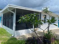 Home exterior shows a sunroom, landscaping, and the house number is visible above the front door at 3530 Beechwood N Ter, Pinellas Park, FL 33781