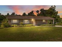 Charming single-story home featuring a brick facade and well-maintained landscaping at 37722 Granada Ave, Dade City, FL 33525
