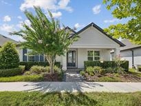 Charming single-story home boasts a well-manicured lawn, inviting entrance, and lush landscaping at 3897 Villamore Ln, Odessa, FL 33556