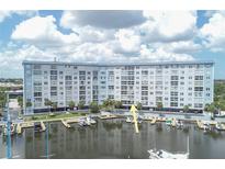 Waterfront condo building with boat docks, ideal for boating enthusiasts and enjoying waterfront living at 4939 Floramar Ter # 203, New Port Richey, FL 34652