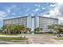 Stunning exterior view of a multi-story condominium complex with balconies and lush landscaping at 4939 Floramar Ter # 812, New Port Richey, FL 34652