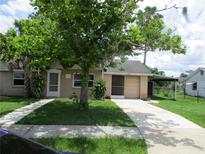 Charming single-story home featuring a well-maintained front yard, driveway, and cozy facade at 6030 17Th St, Zephyrhills, FL 33542