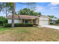 Charming single-story home with manicured landscaping, stone accents and a two-car garage at 6509 Pine Meadows Dr, Spring Hill, FL 34606