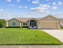 Charming single-story home featuring a well-manicured lawn and a two-car garage at 8401 Pavilion Dr, Hudson, FL 34667