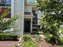Inviting front entrance with well-maintained landscaping and charming curb appeal at 9474 Nakoma Way # E, Weeki Wachee, FL 34613