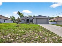 Charming single-story home with a well-manicured lawn and attached two-car garage at 2476 Magellan Ave, Spring Hill, FL 34608
