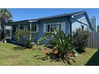 Charming blue home featuring manicured landscaping and a cozy front porch at 4027 31St N Ave, St Petersburg, FL 33713