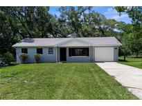 Charming one-story home featuring a well-manicured lawn and an attached one-car garage at 5215 Azalea Cir, Dade City, FL 33523