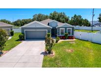 Charming single-story home with well-manicured lawn, attached garage, and beautiful landscaping at 8855 Prairie Creek Dr, New Port Richey, FL 34655