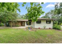 Charming single-story home featuring stone accents and a well-maintained front yard at 34955 Blanton Rd, Dade City, FL 33523