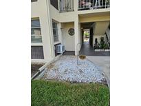 Exterior of the unit with rock landscaping, walkway, and covered entrance at 4743 Jasper Dr # 107, New Port Richey, FL 34652