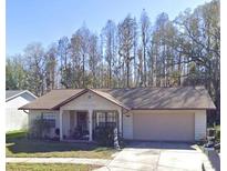 Charming single-story home with a well-manicured lawn and attached two-car garage at 8122 Matthew Dr, New Port Richey, FL 34653