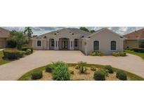 Elegant home featuring a large driveway, lush landscaping, and a meticulously maintained front yard at 9188 Mississippi Run, Weeki Wachee, FL 34613