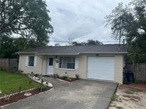 Charming single-story home featuring a well-maintained front yard and a one car garage with a paved driveway at 9536 Mayson St, New Port Richey, FL 34654