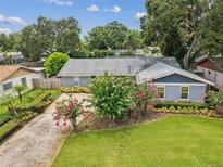 Charming single-story home featuring well-manicured landscaping, a lush green lawn, and a long driveway at 2827 Oak Tree Ln, Palm Harbor, FL 34684