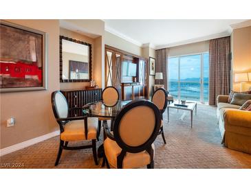 Elegant dining area with glass table and four chairs, offering city views at 135 E Harmon Ave # 3014, Las Vegas, NV 89109