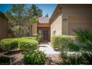 Tan two-car garage home with walkway and landscaping at 9433 Grand Mesa Dr # 0, Las Vegas, NV 89134