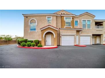 Two-story townhome with attached garage and landscaping at 10001 Peace Way # 2322, Las Vegas, NV 89147