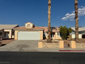 Single-story house with a two-car garage and desert landscaping at 4848 Califa Dr, Las Vegas, NV 89122