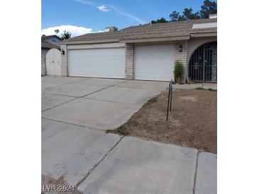 Three-car garage with automatic doors at 3214 Anacapa Way, Las Vegas, NV 89146