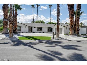 Mid-century modern home with a landscaped yard and palm trees at 324 Park Way, Las Vegas, NV 89106