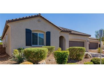 Beautiful home exterior with dark shutters and landscaping at 919 Jason Alexander Ave, North Las Vegas, NV 89031