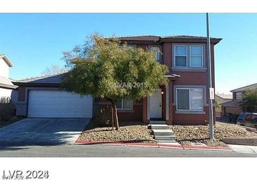 Two-story house with attached garage and landscaped front yard at 5308 La Quinta Hills St, North Las Vegas, NV 89081