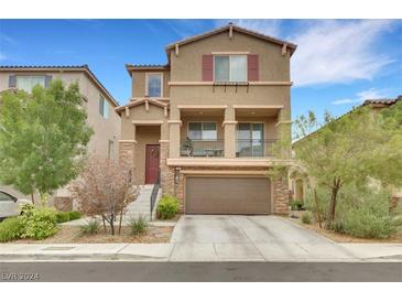 Two story house with a two car garage and landscaping at 7689 Monomoy Bay Ave, Las Vegas, NV 89179