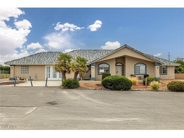 One-story home with tile roof and landscaped yard at 3241 E Winery Rd, Pahrump, NV 89048