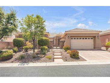 One-story house with stone accents and landscaped yard at 7145 Cypress Run Dr, Las Vegas, NV 89131