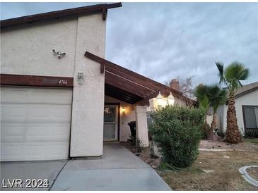 House exterior with a white garage door and landscaping at 4766 S Mojave Rd, Las Vegas, NV 89121