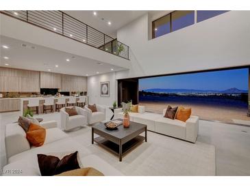 Open living room with high ceilings, modern furniture, and stunning views at 1458 Dragon Stone Pl, Henderson, NV 89012