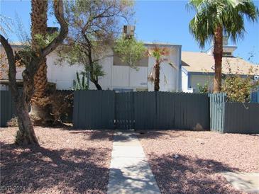 Front view of a house with a gray fence and walkway at 4285 White Sands Ave, Las Vegas, NV 89121