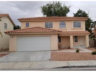 Two-story house with tan exterior and attached garage at 970 Flapjack Dr, Henderson, NV 89014