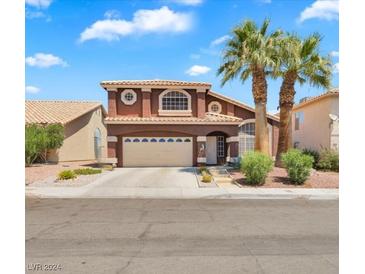 Two-story house with attached garage and palm trees at 8872 Dove Cove Dr, Las Vegas, NV 89129