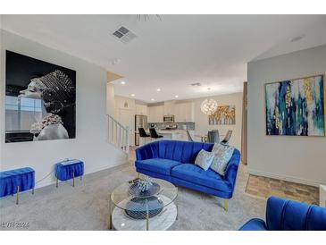 Bright living room with blue velvet sofa and large artwork at 25 Barbara Ln # 67, Las Vegas, NV 89183