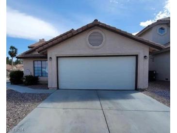 Single story home with attached garage and desert landscaping at 372 Rushing Creek Ct, Henderson, NV 89014