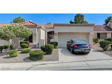 Single-story home with attached garage and well-maintained landscaping at 9661 Blue Bell Dr, Las Vegas, NV 89134