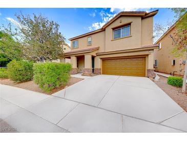 Two story house with attached garage at 3881 Burma Rd, North Las Vegas, NV 89032